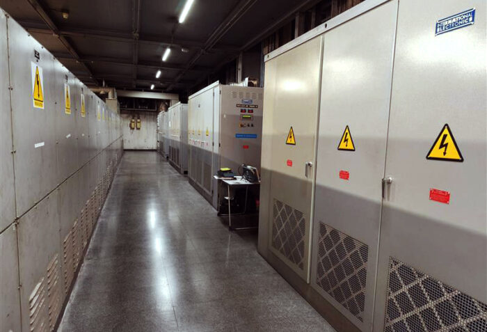 A technical corridor housing a subsynchronous cascade unit alongside multiple electrical cabinets and auxiliary components used for controlling high‑power slip ring motor systems in industrial environments.